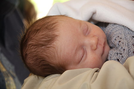 baby sleeping covered with blanket thumbnail