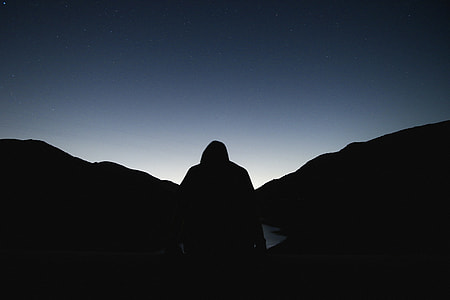 man near mountain during nightime thumbnail