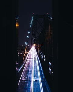 time-lapse photography of bridge nighttime thumbnail