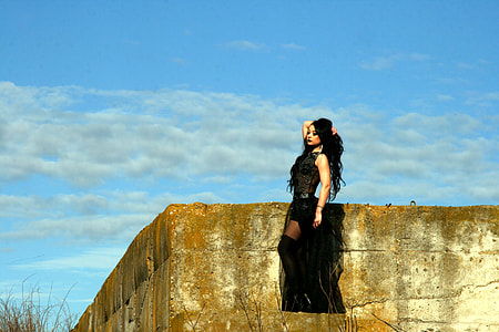 woman in black floral sleeveless long dress standing on concrete surface during daytime photo thumbnail