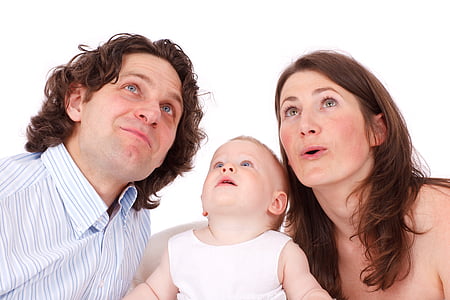 person taking photo of man and woman with toddler in white sleeveless top thumbnail
