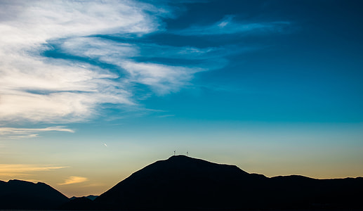 silhouette of mountain under blue sky and white clouds thumbnail