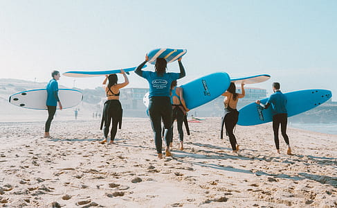 Group of People Carrying Surfboards thumbnail
