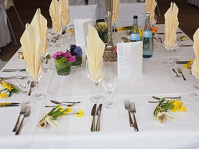 table setting with flowers and bottle on table thumbnail