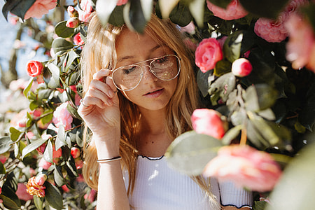 woman standing beside pink flowers thumbnail