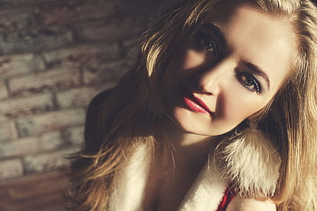photography of woman in white coat tilting head sideways thumbnail