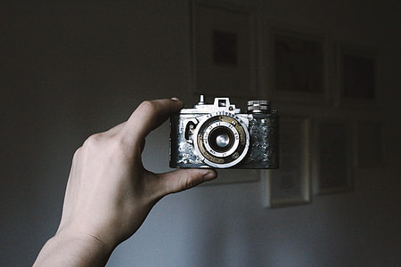 person holding gray film camera thumbnail