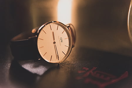 round white analog watch with black leather strap at 9:15 thumbnail