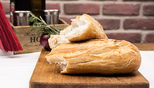 two slice breads on brown wooden chopping board thumbnail