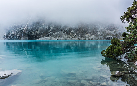 body of water beside mountain thumbnail