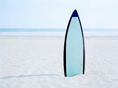 close up photo of blue surfboard on seashore thumbnail