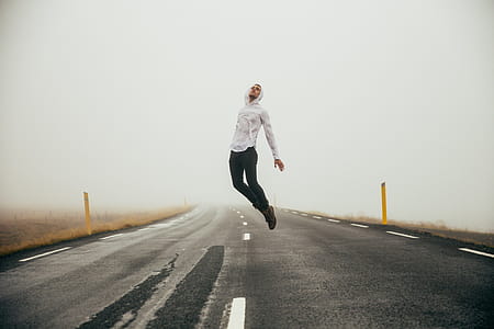 Man Jumping Over Highway Photo thumbnail