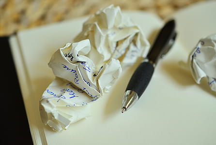 black twist pen beside crumpled paper thumbnail