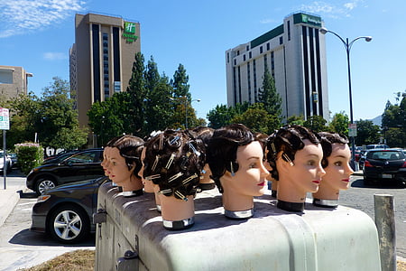 beige mannequin heads near black vehicle during daytime thumbnail