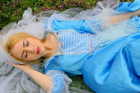 woman wearing blue dress laying on gras thumbnail