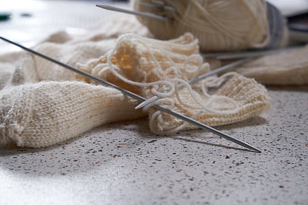 silver metal needle and white yarn thumbnail