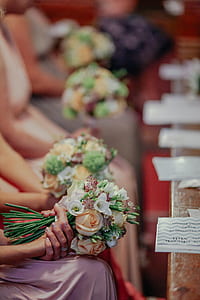 selective focus of women sitting holding bouquet of flowers thumbnail