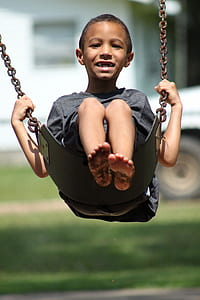 boy wearing heather-gray crew-neck t-shirt sitting on swing chair thumbnail