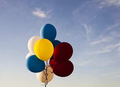 multicolored balloon going up in sky thumbnail