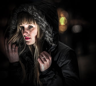 blonde-haired woman in black parka coat thumbnail