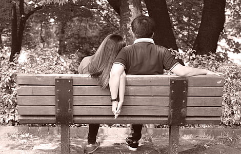 man and woman sitting on bench thumbnail