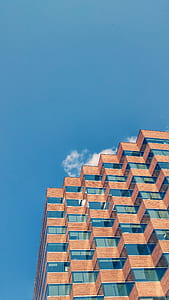 low angle photo of curtain wall high-rise building under bluesky background thumbnail