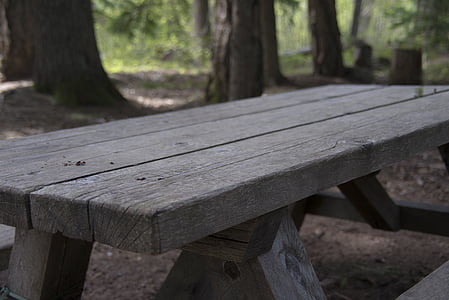 gray wooden picnic bench on gray soil thumbnail