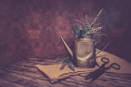lavender flowers in gray watering on brown textile thumbnail