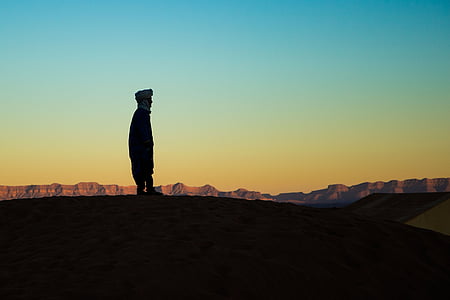 silhouette photography of person on mountain thumbnail