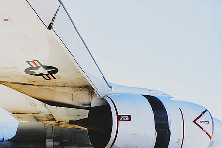 photo of white and black plane under blue sky thumbnail