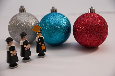 several assorted-color baubles beside three black-and-brown plastic miniatures thumbnail