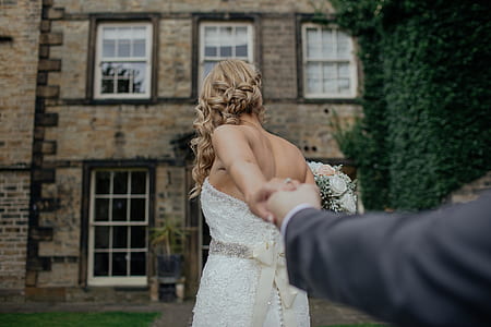 woman wearing white floral wedding dress holding a man thumbnail