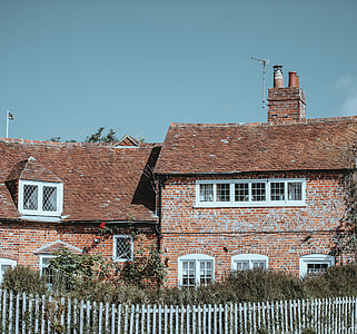 panoramic photography of brick house with fences thumbnail