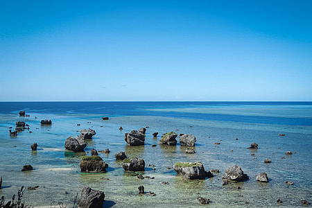 rocks on seashore with calm sea background thumbnail