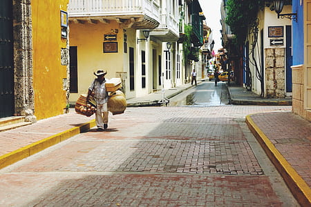 man carrying woven basket thumbnail