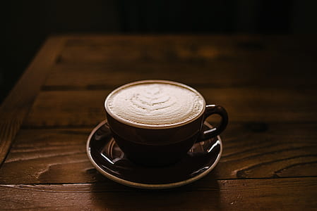 brown ceramic teacup and saucers with coffee thumbnail