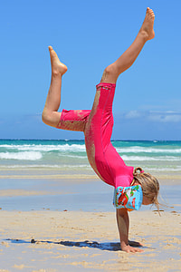 girl handstanding on seashore thumbnail