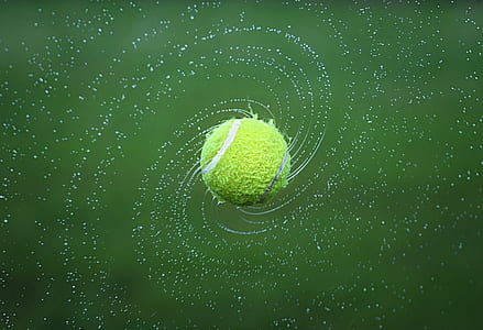 wet tennis ball floats in air thumbnail