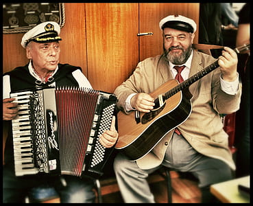 two men holding instrument thumbnail
