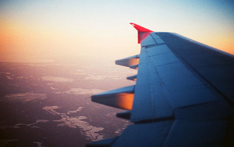 photo of airplane wing during day time thumbnail