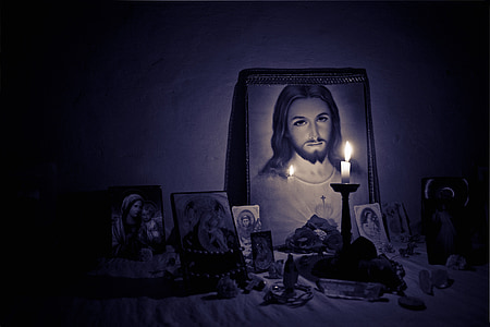 taper candle behind Jesus Christ photo thumbnail