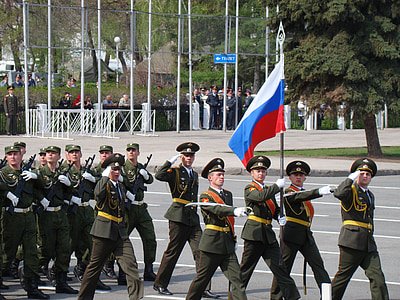 group of military men marching holding Russian flag thumbnail