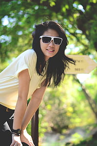 Woman in Yellow Shirt With Hands on Knee thumbnail