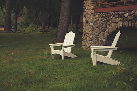 two white adirondack chairs on grass thumbnail