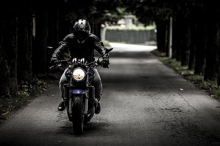 grayscale photo of man in jacket riding motorcycle thumbnail