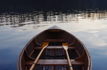 brown wooden boat on body of water thumbnail