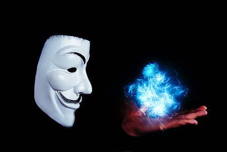 person wearing Jay Fawkes mask with blue fire on hand thumbnail