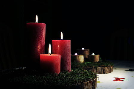 three lighted red pillar candles thumbnail