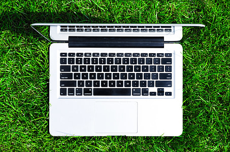 flat-lay photography of MacBook Air on top of green grass field thumbnail