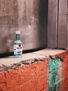clear glass bottle on gray concrete wall thumbnail